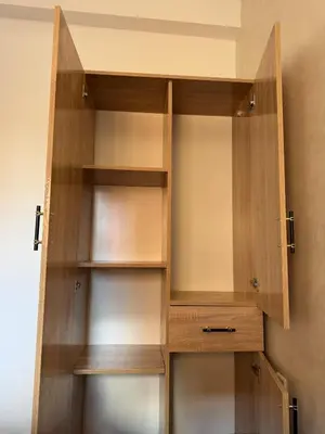a wooden book shelf in a room at Cozy Apt Near Marrakech Airport in Marrakech