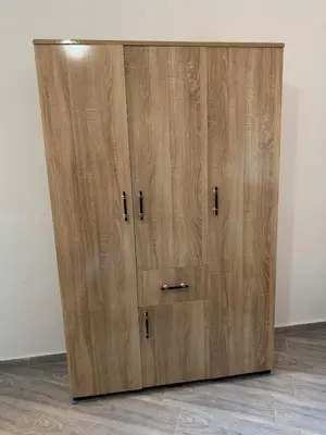 a large wooden cabinet with two doors in a room at Cozy Apt Near Marrakech Airport in Marrakech