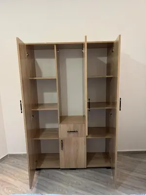 a wooden book shelf in a room at Cozy Apt Near Marrakech Airport in Marrakech