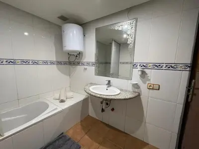 a bathroom with a sink and a bath tub at Le grand jardin Marrakech in Marrakech