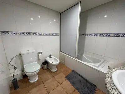 a bathroom with a toilet and a tub and a sink at Le grand jardin Marrakech in Marrakech