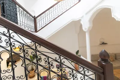 a staircase with wrought iron railings in a home at HM40 I Moroccan Riad with Residential Pool in Marrakech