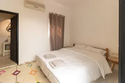 a bedroom with a white bed and a mirror at HM40 I Moroccan Riad with Residential Pool in Marrakech