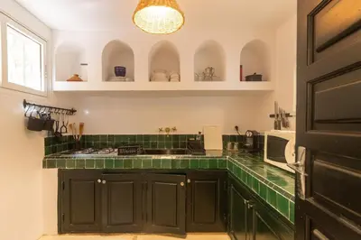 a kitchen with green cabinets and a green tile counter at HM40 I Moroccan Riad with Residential Pool in Marrakech