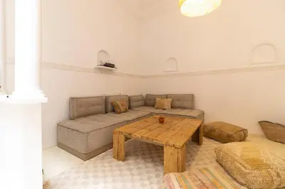 a living room with a couch and a table at HM40 I Moroccan Riad with Residential Pool in Marrakech