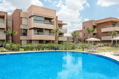 a large blue swimming pool in front of a building at appartement- Marrakech-Sapphire in Marrakech