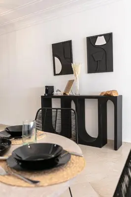 a dining room with a table with black plates on it at Place To Be Marrakech Downtown in Marrakech