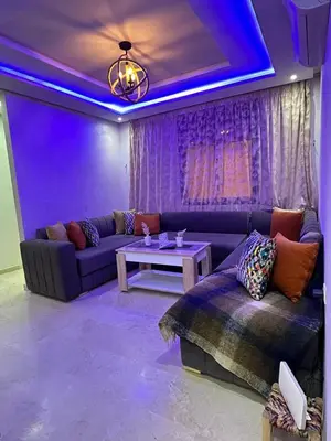 a living room with a couch and a table at appartement elegant in Marrakech