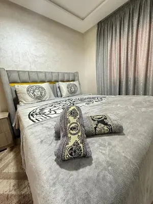 a bedroom with a bed with a pillow on it at appartement elegant in Marrakech