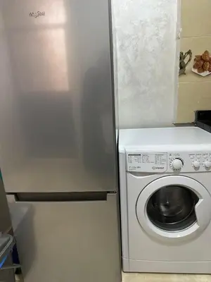 a refrigerator with a washing machine in a kitchen at appartement elegant in Marrakech