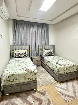 a bedroom with two beds in a room at appartement elegant in Marrakech