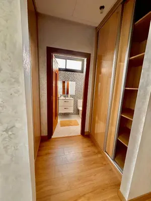 a hallway with a door to a bathroom with a sink at Villa ARGANA 6 chambres avec piscine jacuzzi et hammam à Argan Golf 10 min du centre in Marrakech