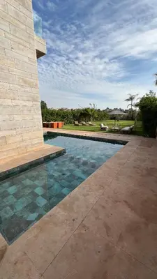 a swimming pool in front of a building at Villa ARGANA 6 chambres avec piscine jacuzzi et hammam à Argan Golf 10 min du centre in Marrakech