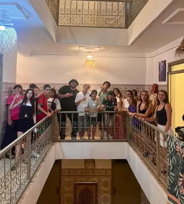 a group of people standing on a staircase at Red Vibes Hostel Marrakech in Marrakech