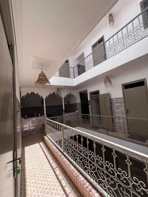 a hallway of a building with a balcony at Red Vibes Hostel Marrakech in Marrakech