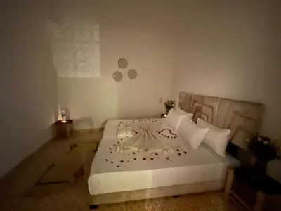 a bedroom with a white bed with flowers on it at Red Vibes Hostel Marrakech in Marrakech