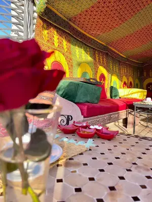 a room with a red couch and red shoes on the floor at Riad Dar Mamouni in Marrakech