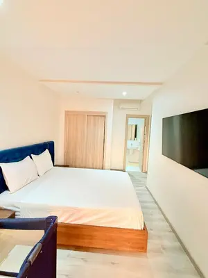 a bedroom with a bed and a flat screen tv at N17 Agréable Confortable & Près De Gueliz in Marrakech