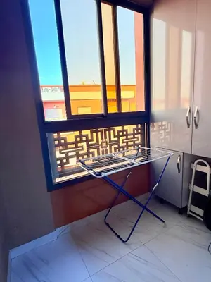 a glass table in a room with a window at N17 Agréable Confortable & Près De Gueliz in Marrakech