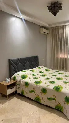 a bedroom with a large bed with flowers on it at Top apartment Great location in Marrakech