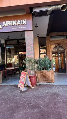 a restaurant with a sign in front of a building at Top apartment Great location in Marrakech
