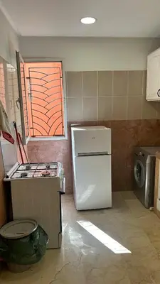 a kitchen with a white refrigerator and a window at Top apartment Great location in Marrakech