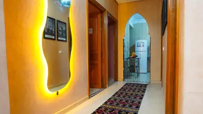 a hallway with yellow walls and a hallway with a rug at Marrakech Luxury apartment in Marrakech