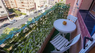 a table and chairs on a balcony with a street at Marrakech Luxury apartment in Marrakech