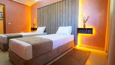 a hotel room with two beds in a room at Marrakech Luxury apartment in Marrakech