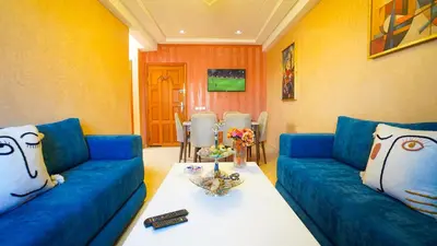 a living room with a blue couch and a table at Marrakech Luxury apartment in Marrakech