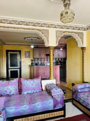 a living room with a couch and a kitchen at Apartment Msholidays 1 CH Marrakech pool in Marrakech