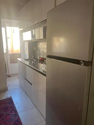 a white kitchen with a refrigerator in a room at Au cœur de la ville ocre in Marrakech