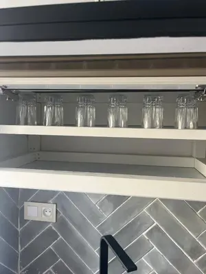 a row of glasses on a shelf in a kitchen at Au cœur de la ville ocre in Marrakech
