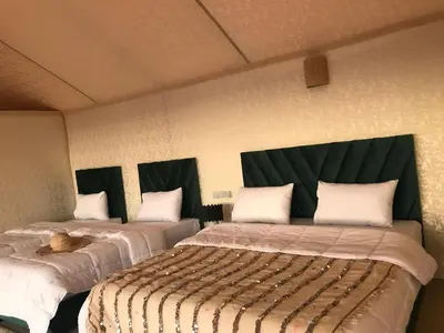 two beds in a room with black headboards at Quad Alia Marrakech in Marrakech