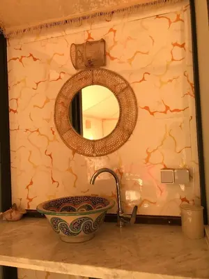a bathroom with a sink and a mirror at Quad Alia Marrakech in Marrakech