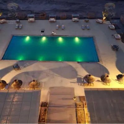 an overhead view of a swimming pool at night at Quad Alia Marrakech in Marrakech