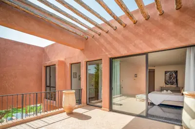 a room with a balcony with glass doors at Sublime Villa Neuve Marrakech - Piscine Chauffée in Marrakech