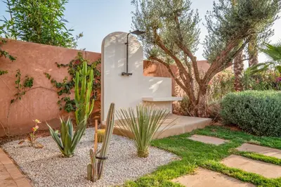 a garden with a shower and cactuses in a yard at Sublime Villa Neuve Marrakech - Piscine Chauffée in Marrakech