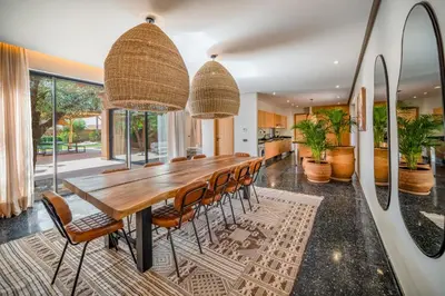 a dining room with a long wooden table and chairs at Sublime Villa Neuve Marrakech - Piscine Chauffée in Marrakech