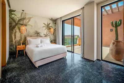 a bedroom with a white bed and a large window at Sublime Villa Neuve Marrakech - Piscine Chauffée in Marrakech