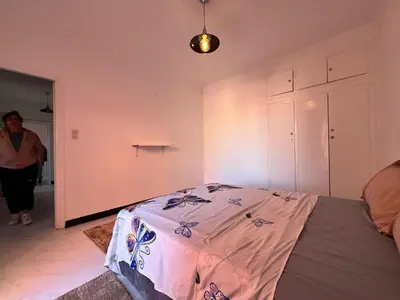 a woman standing in a room with a bed at Résidence zitouna in Marrakech