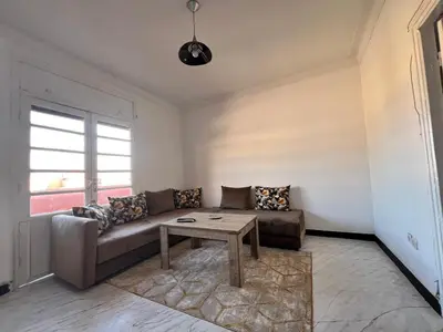 a living room with a couch and a table at Résidence zitouna in Marrakech