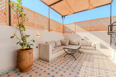 a living room with a couch and a table at Riad Dar Amarena Exclusif BreakFast in Marrakech