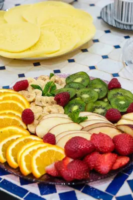a platter of fruit and vegetables on a table at Riad Dar Amarena Exclusif BreakFast in Marrakech