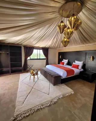 a bedroom with a large bed with a tent at Eden Lodges & SPA-Boutique Hôtel de Luxe in Marrakech