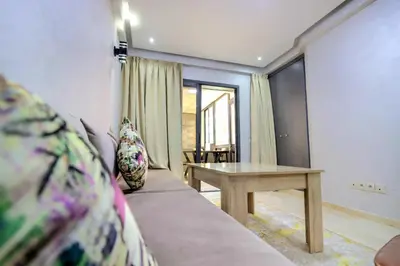a living room with a couch and a table at Residence Jnan atlas gueliz in Marrakech