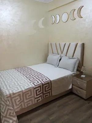 a bedroom with a bed and a sign on the wall at Charming Marrakech apartment in Marrakech