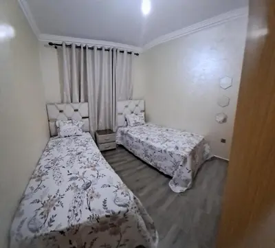 a bedroom with two beds and a window at Charming Marrakech apartment in Marrakech