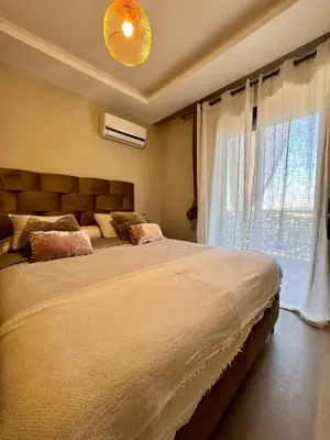 a bedroom with a large bed and a window at Charming appartement 1 bed in Guéliz in Marrakech