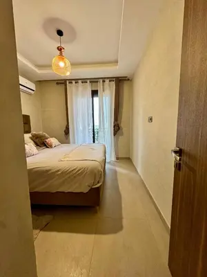 a bedroom with a bed and a window at Charming appartement 1 bed in Guéliz in Marrakech
